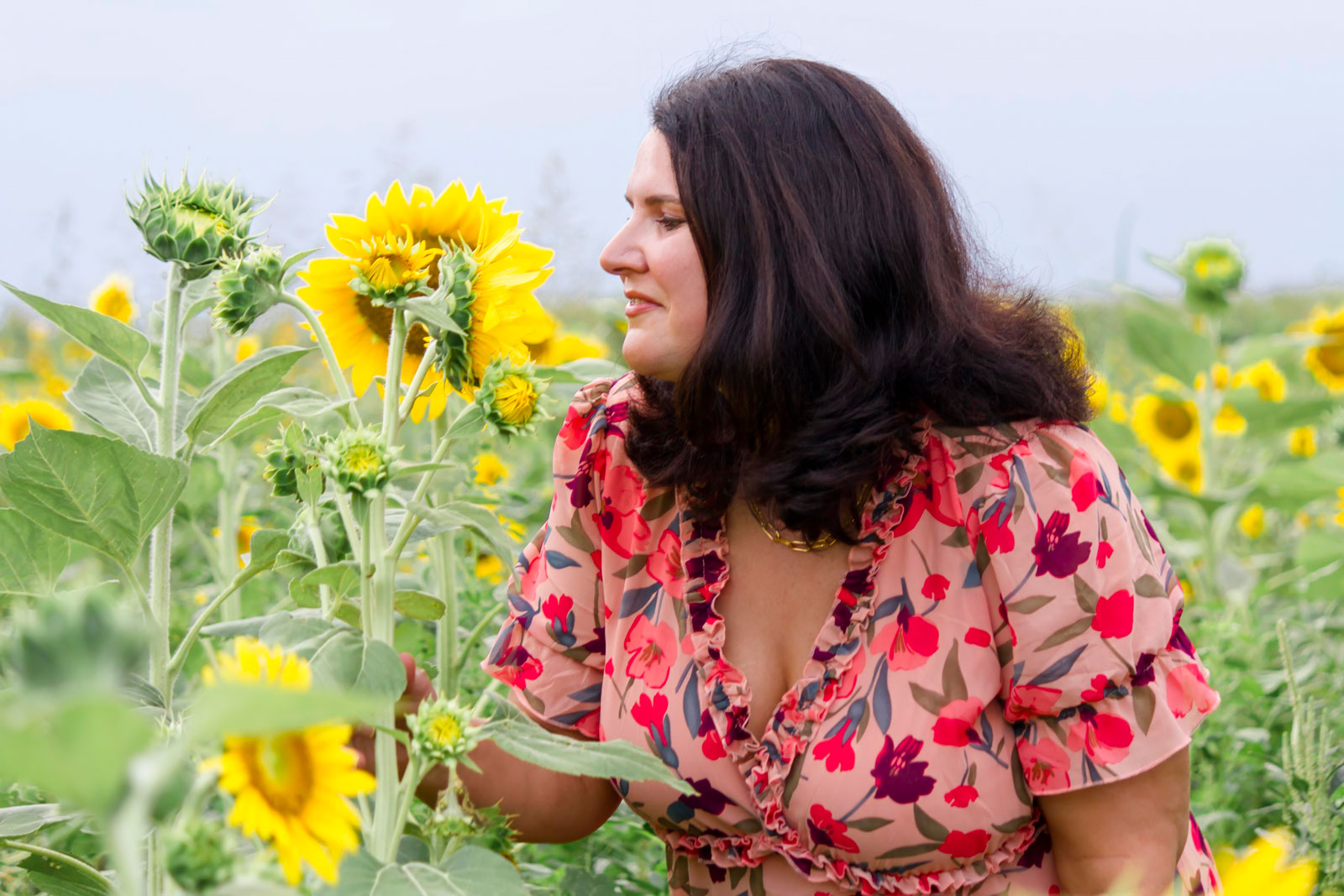 Mom sniffing the sunflower at the sunflower field in Belcher LA