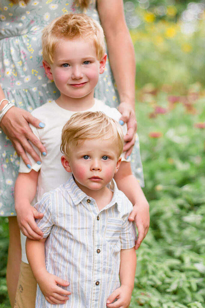 Two little brothers standing in the wildflower field in Belcher, LA