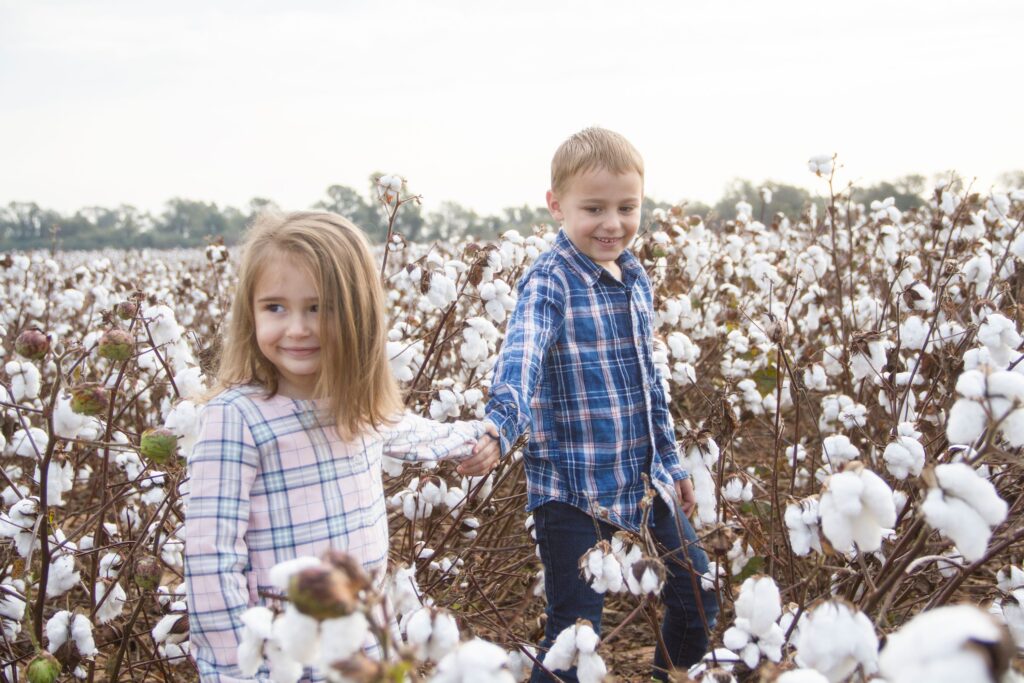 little girl and little boy holding hands at the cotton field in belcher, la