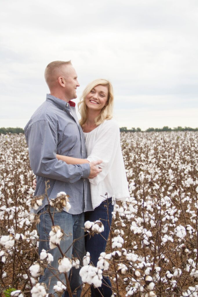 woman and man aka husband and wife hugging at the cotton field in belcher, la