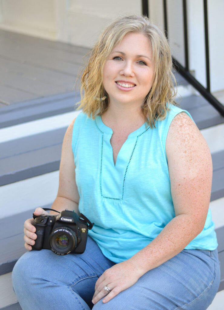 woman sitting on the steps while holding her canon camera in Benton, Louisiana