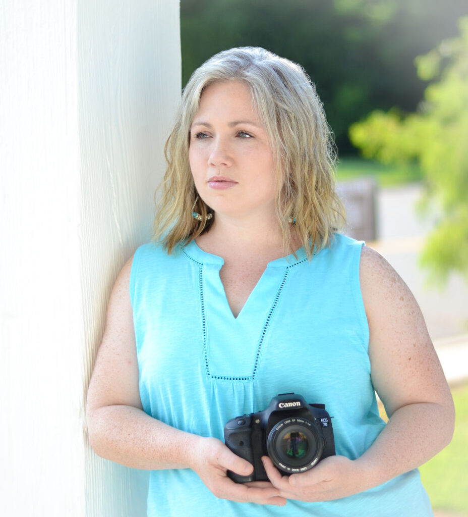 woman holding her canon camera while staring off to the side in Benton, Louisiana