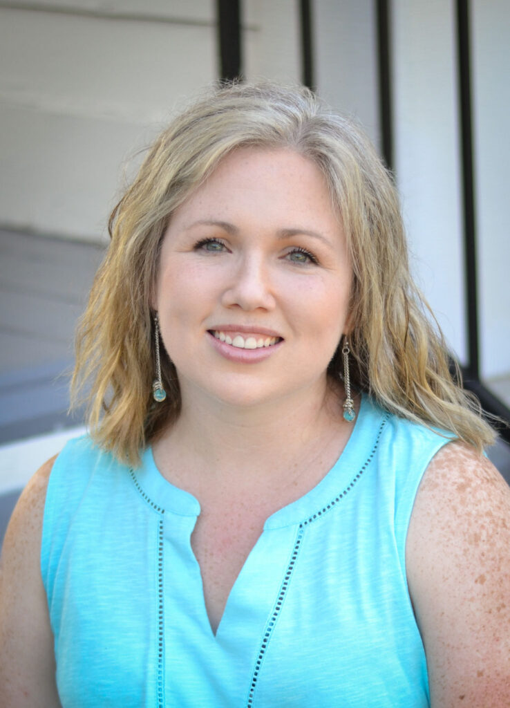 woman sitting on the steps smiling at the camera in Benton, Louisiana