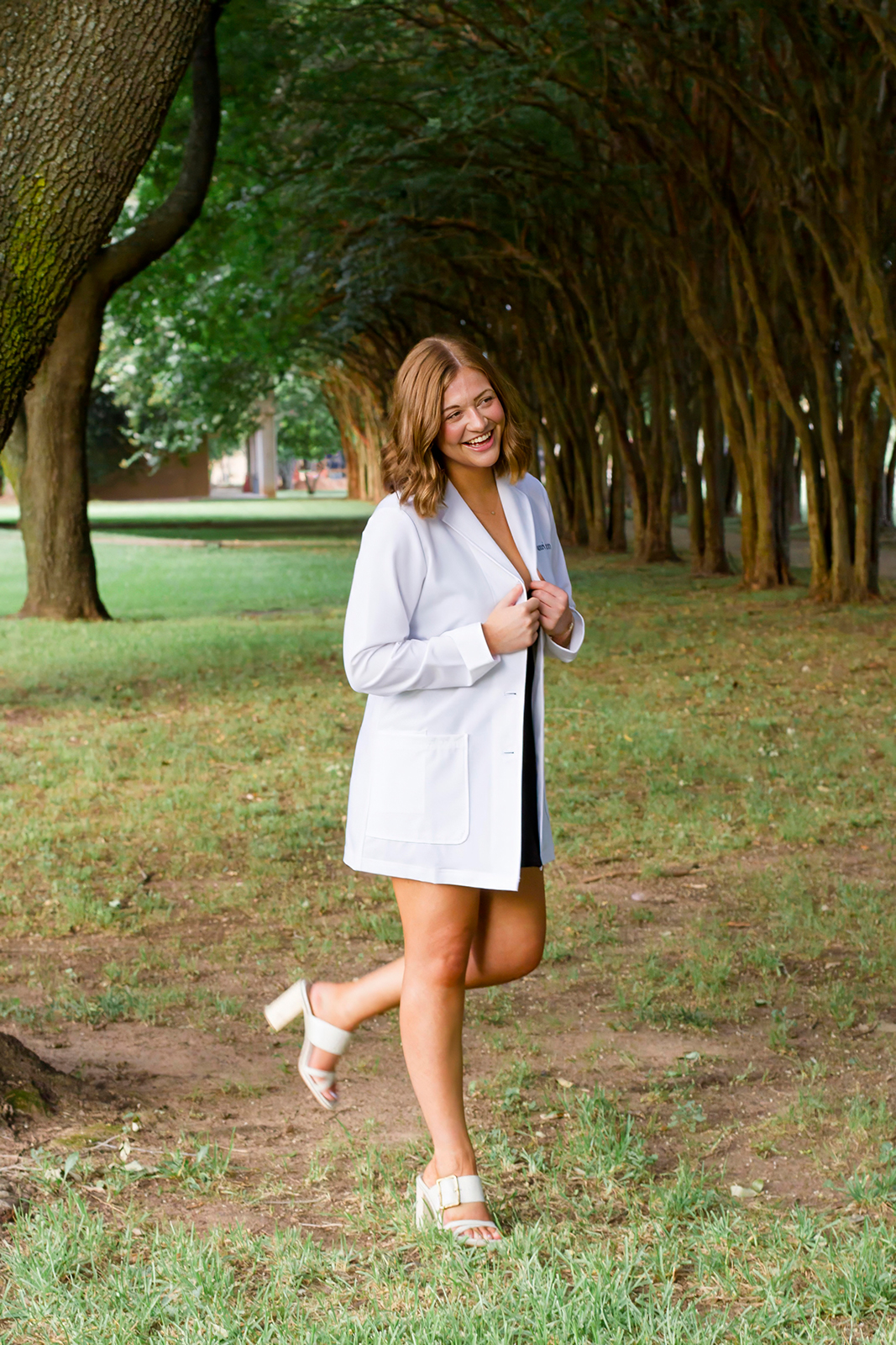 college grad med senior wearing white coat on LSUS campus Shreveport LA