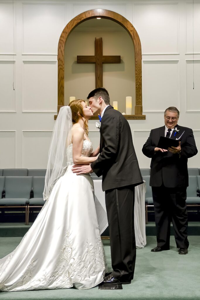 groom and bride kissing as husband and wife at the Rose Park Baptist in Shreveport, LA