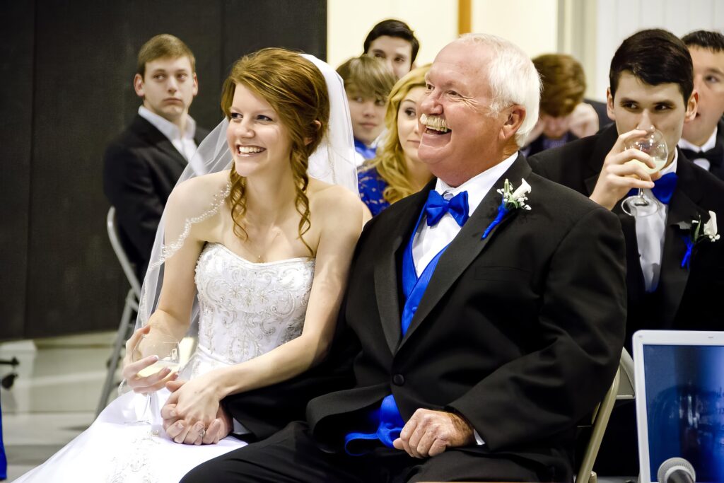 bride with her father sitting down smiling in Shreveport, LA