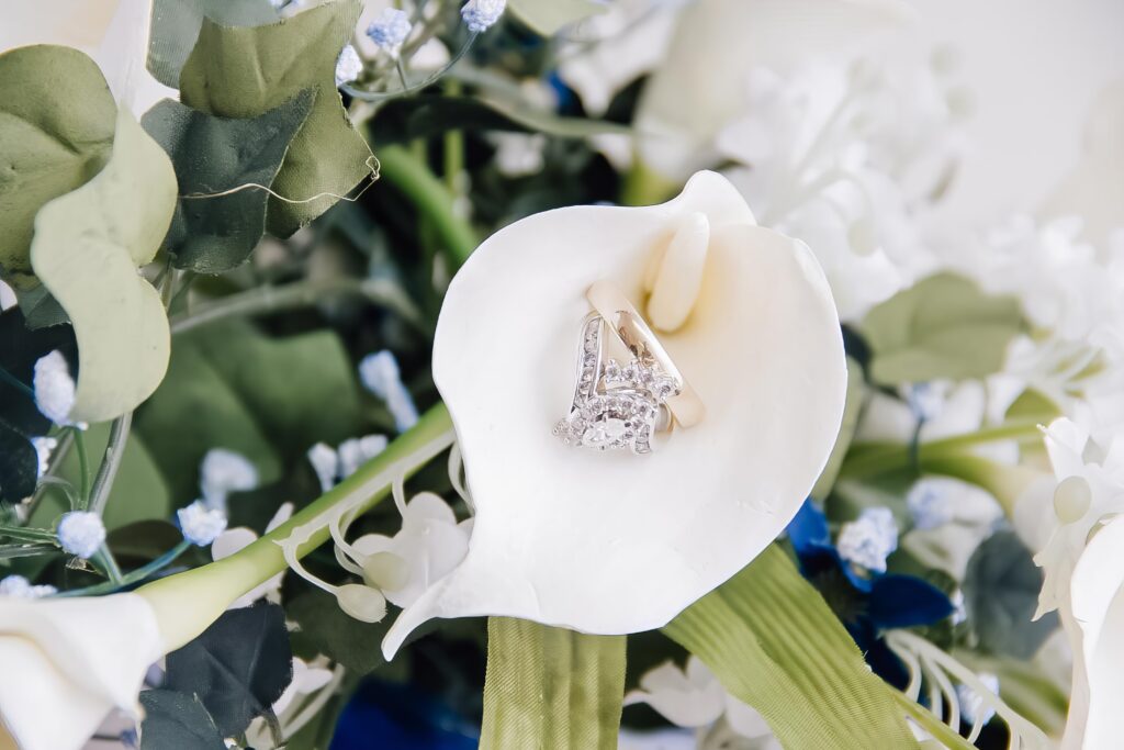 bride and groom's wedding ring inside a flower petal in Shreveport, LA