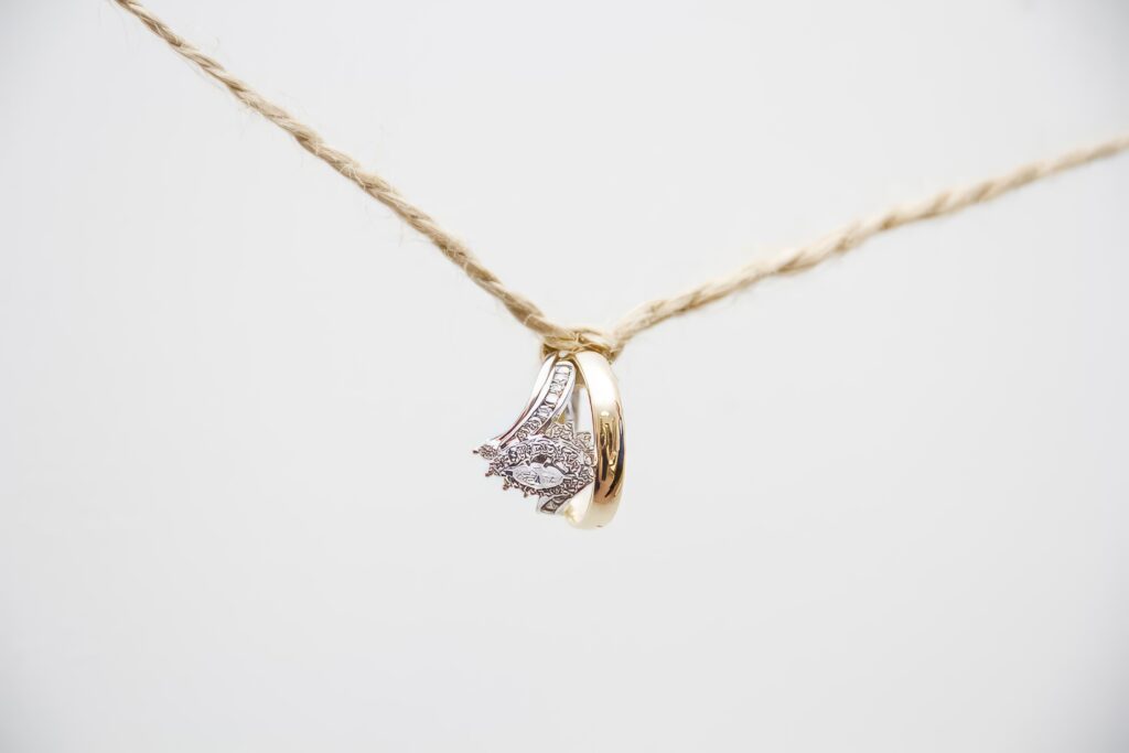 bride and groom's wedding rings hanging on a rope in Shreveport, LA