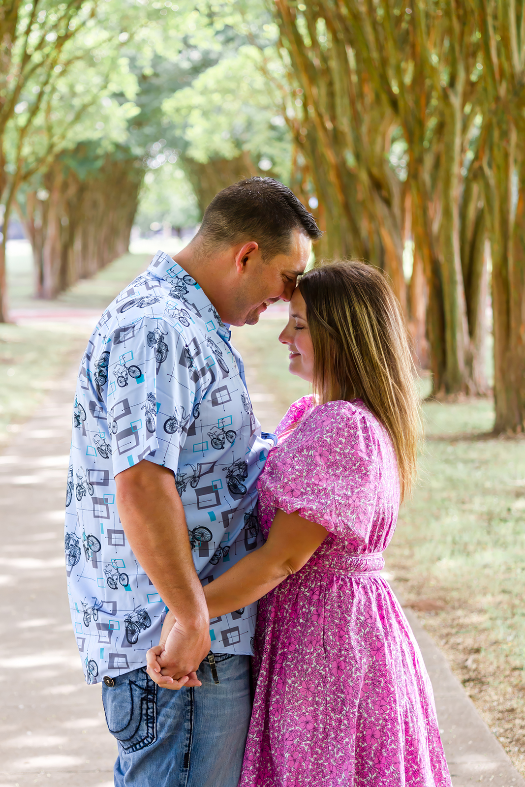 man and woman facing each other holding hands on a pathway on LSUS campus in Shreveport, LA