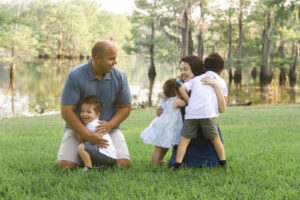 Family holding each other and playing at Bistineau State Park in Doyline, LA