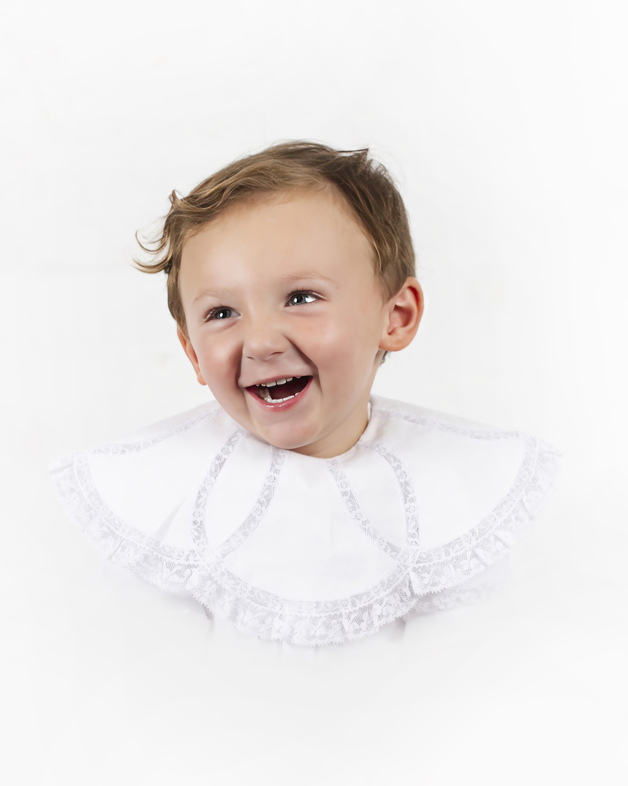 little boy toddler smiling and laughing while looking right during a heirloom portrait home studio session in bossier city, la