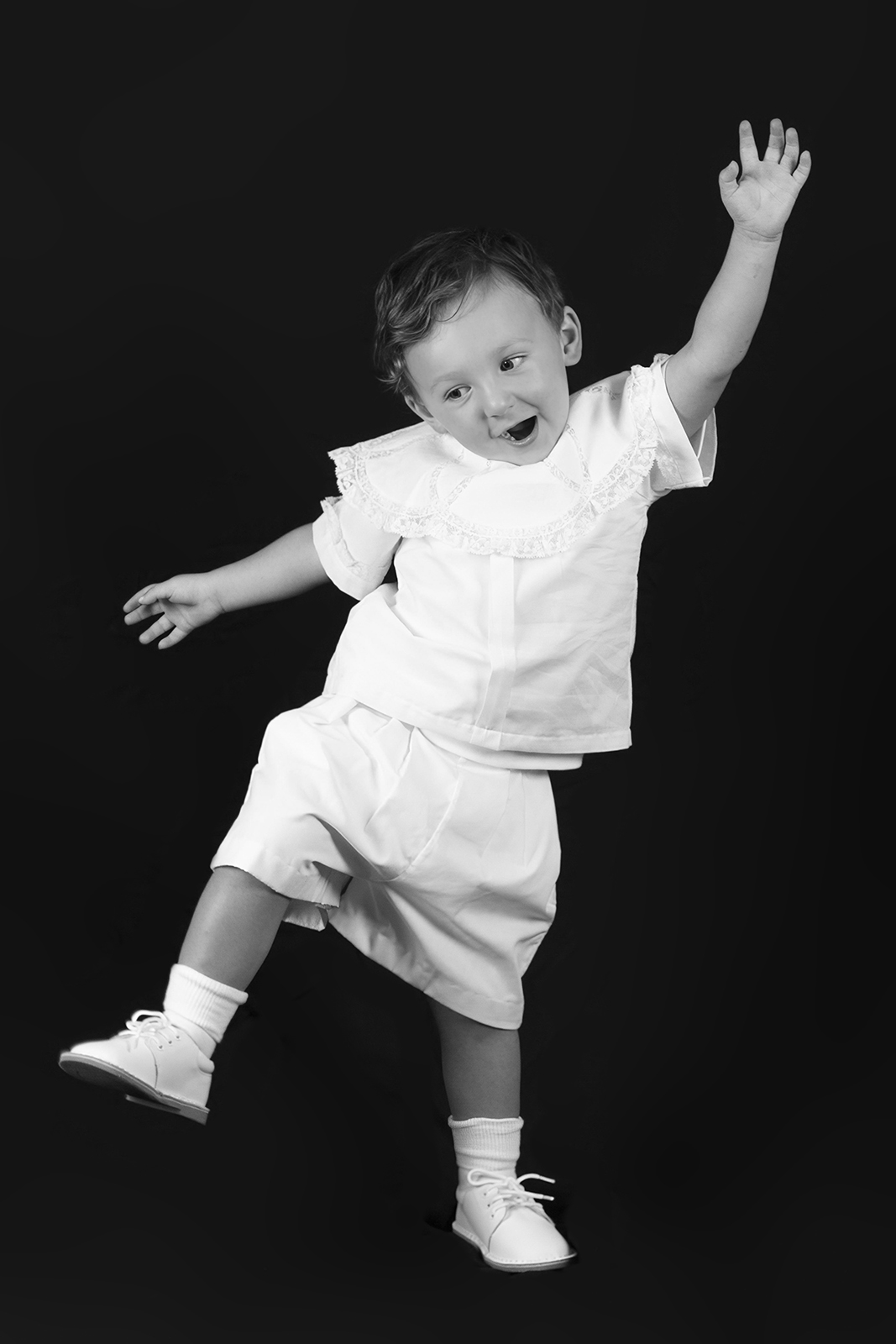 little boy toddler being silly with one leg up during personality portrait home studio session in bossier city, la