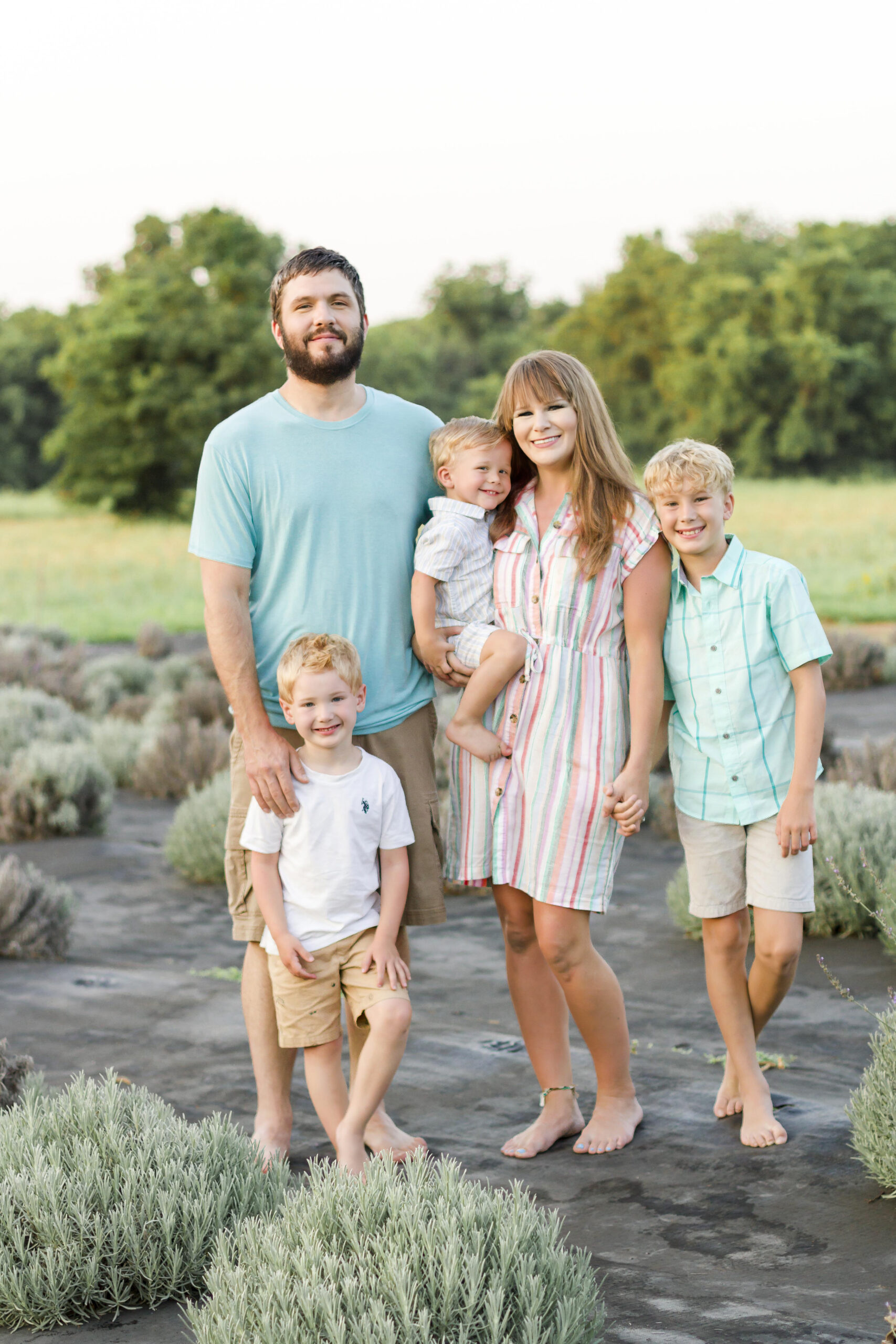 family of five standing and smiling at the Dixie Farm Lavender in Shreveport, LA