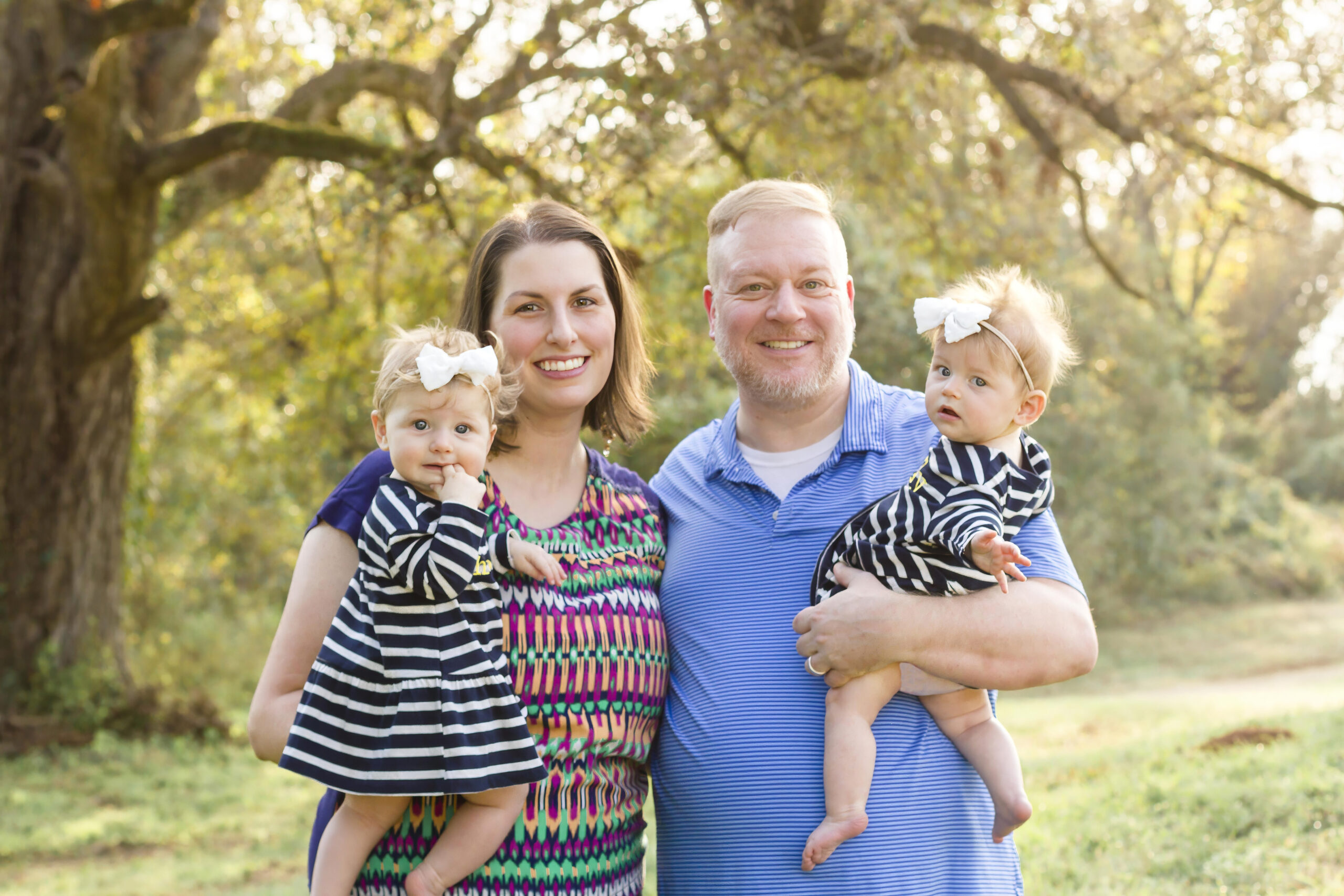 mom and dad both holding their twin baby girls in Bossier City, la at Red River Wildlife Refuge Center