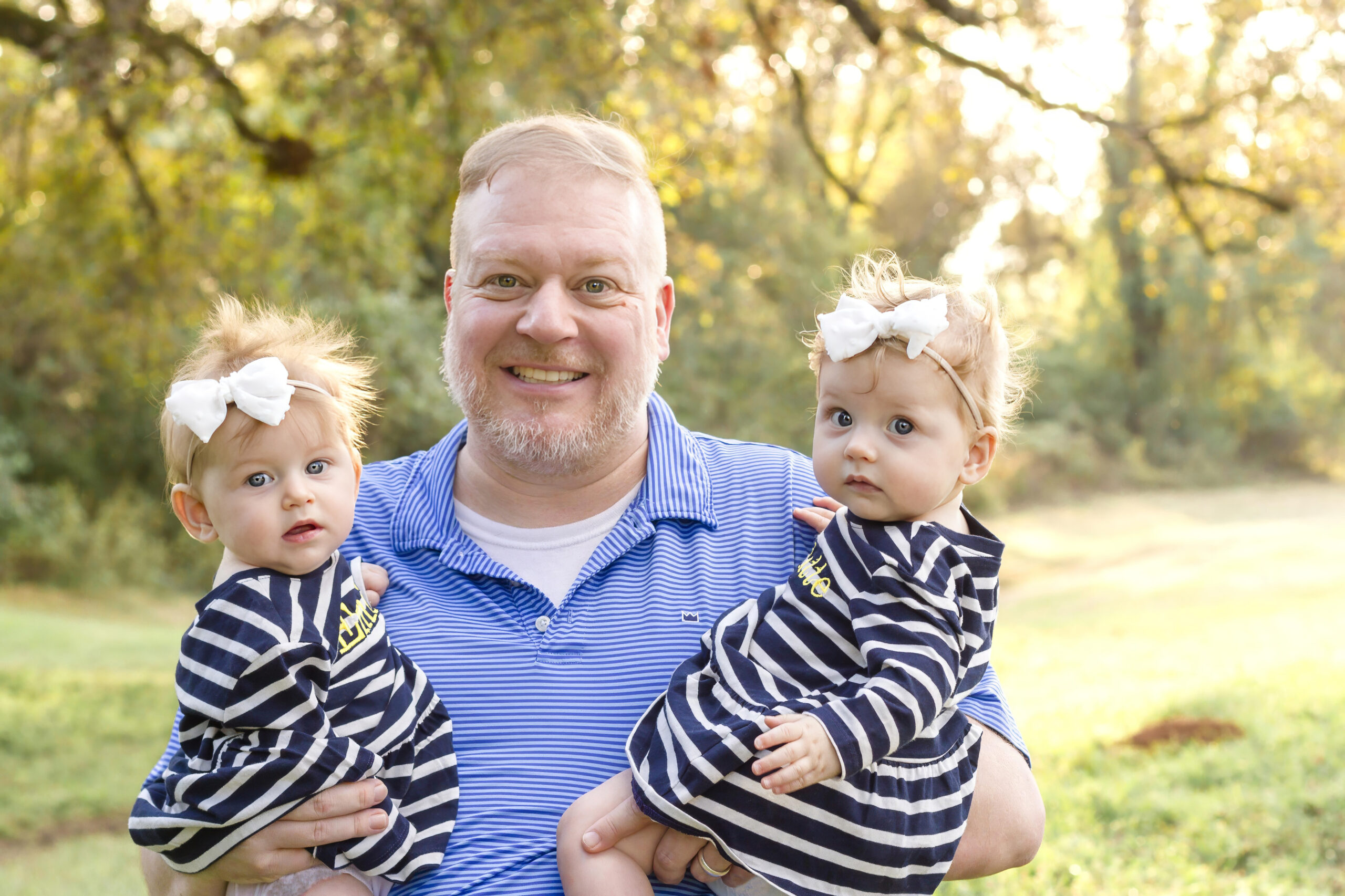 dad holding his twin baby girls in Bossier City, la at Red River Wildlife Refuge Center