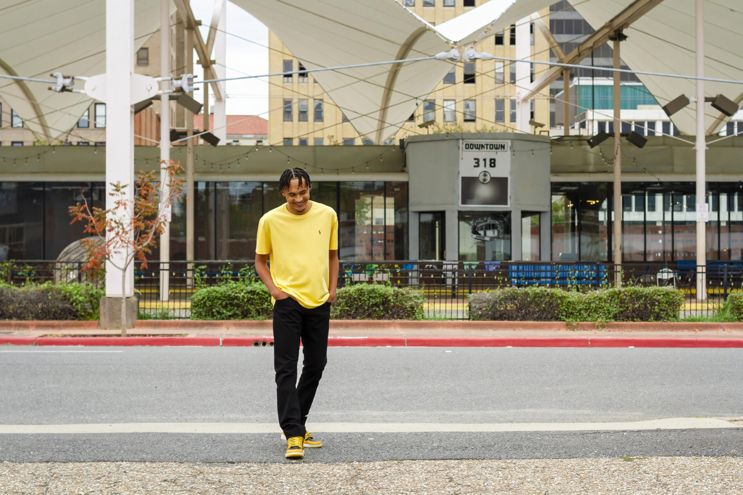 senior boy smiling and laughing near his area code 318 in downtown Shreveport, LA