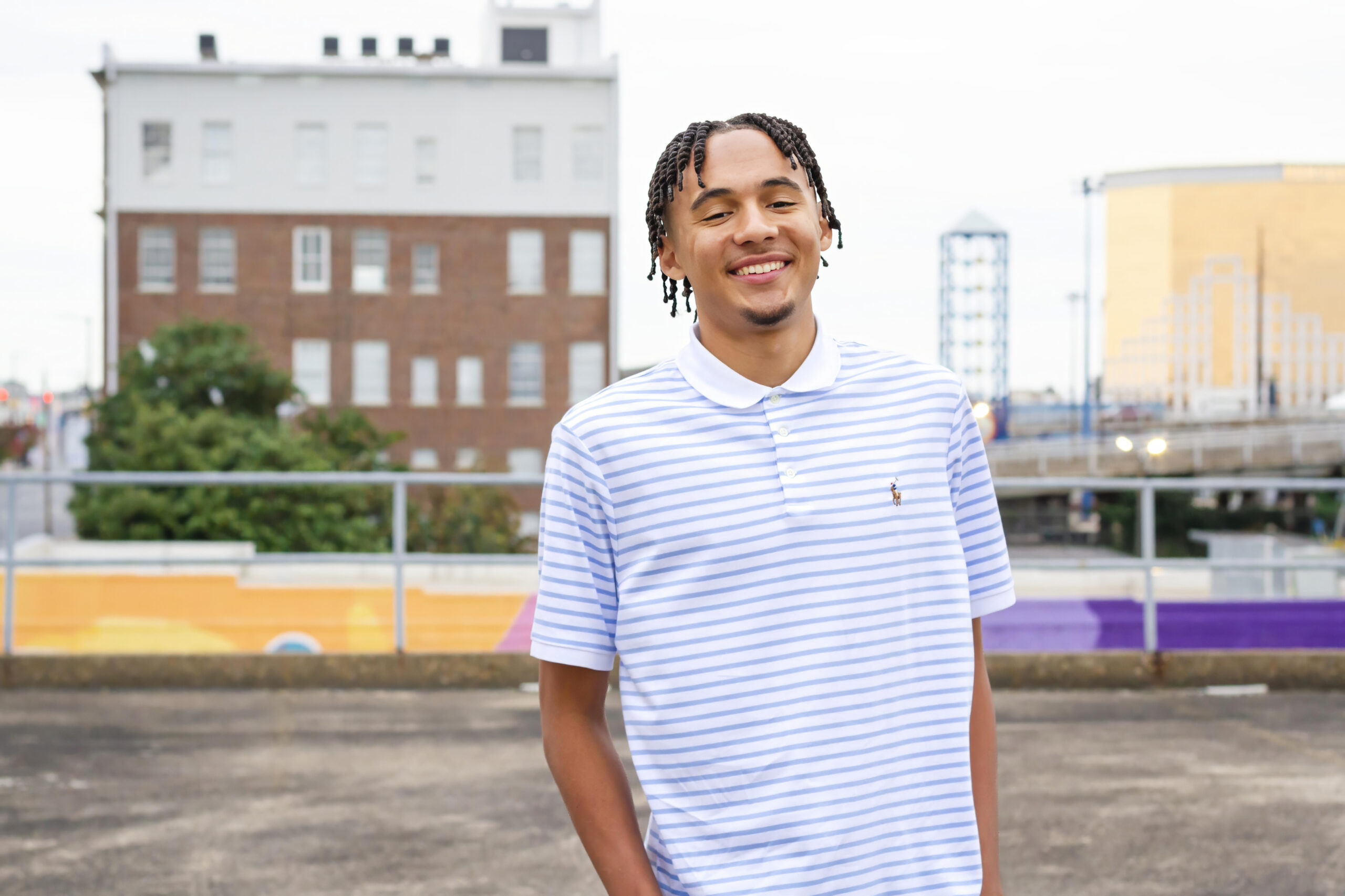 senior boy smiling while standing on an empty parking garage in downtown Shreveport, LA