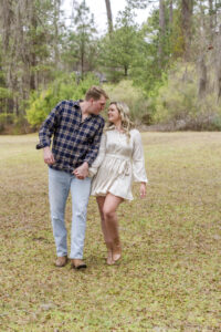 girl playfully bumping into boy as they are walking in Doyline, LA at Lake Bistineau