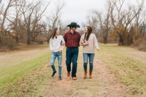 siblings walking down a path locking arms at Red River Refuge Center in Bossier City, LA