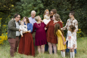 family members looking at the funniest person in the group in a grassy field in Shreveport, LA