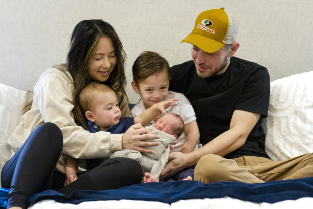 family holding newborn baby boy in their house in Bossier City, LA